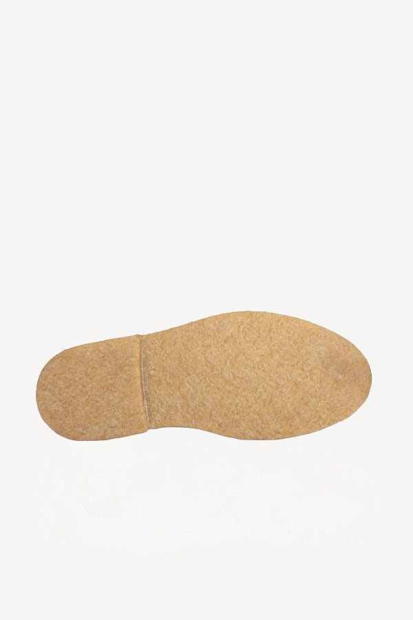 Sole view of off-white montana suede and sherling ankle boot on white background, with no model shown.
