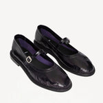 Front slanted view of plum patent trish ballet flat on white background with no model shown.
