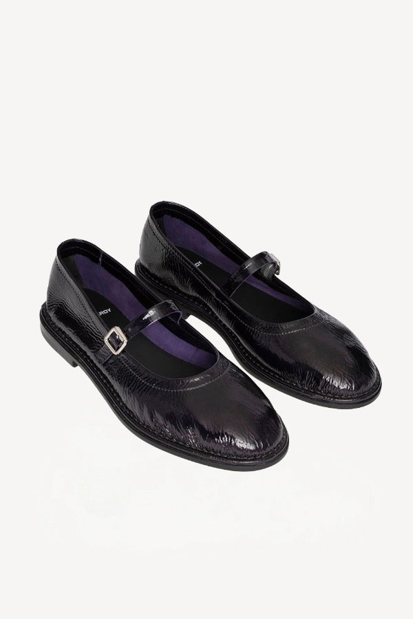 Front slanted view of plum patent trish ballet flat on white background with no model shown.