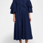 Front view of navy fiesta shirt dress on model wearing beige/brown platforms, against a white background.