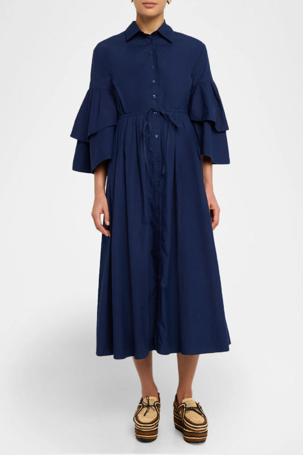 Front view of navy fiesta shirt dress on model wearing beige/brown platforms, against a white background.