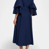 Back view of navy fiesta shirt dress on model wearing beige/brown platforms, against a white background.