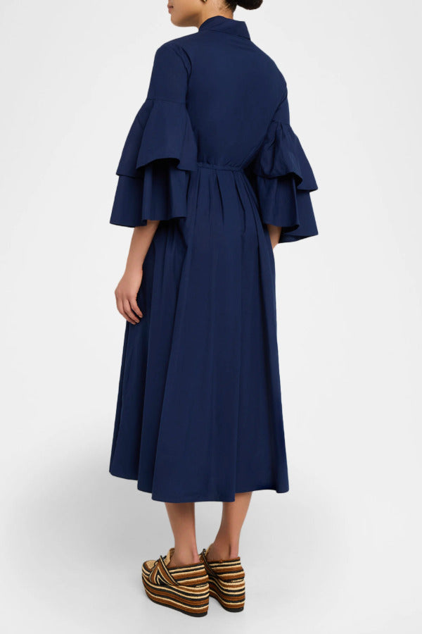 Back view of navy fiesta shirt dress on model wearing beige/brown platforms, against a white background.