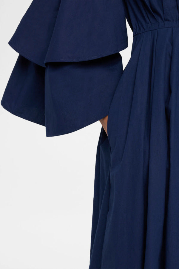 Side closeup view of navy fiesta shirt dress on model, against a white background.