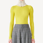 Front closeup view of grigio fantasia bogart wool/silk trousers on model wearing yellow sweater, against a white background.