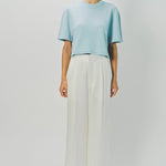 Front view of cielo cashmere cropped t-shirt on model wearing white pants, against a white background.