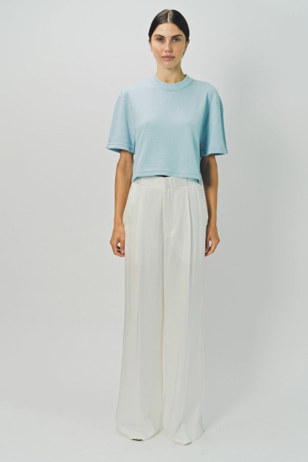Front view of cielo cashmere cropped t-shirt on model wearing white pants, against a white background.