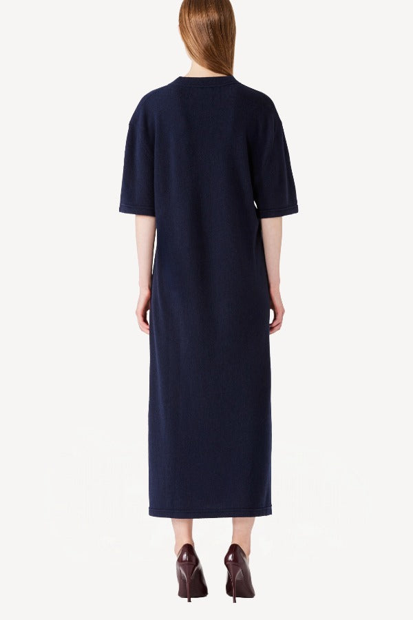 Back view of cielo cashmere long t-shirt dress on model wearing red heels, against a white background.