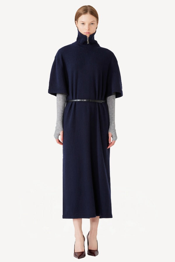 Front view of zipped cielo cashmere long t-shirt on model wearing red heels, against a white background.