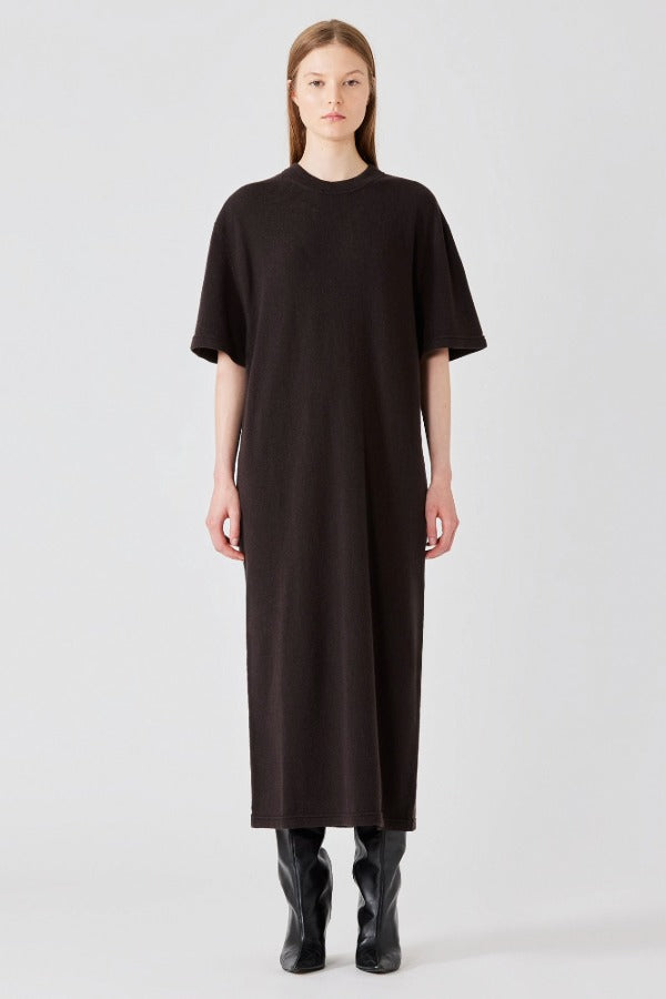 Front view of brown cashmere long t-shirt dress on model wearing boots, against a white background.