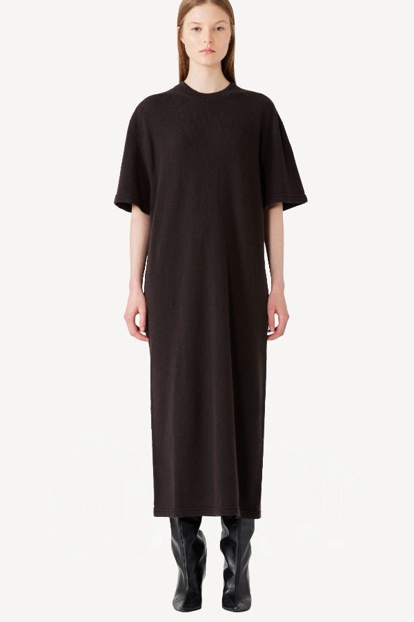 Front view of brown cashmere long t-shirt dress on model wearing black boots, against a white background.