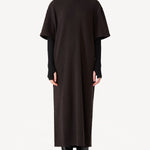 Front zipped view of brown cashmere long t-shirt dress on model wearing black boots, against a white background.