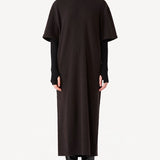 Front zipped view of brown cashmere long t-shirt dress on model wearing black boots, against a white background.