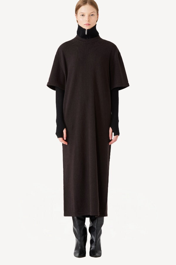 Front zipped view of brown cashmere long t-shirt dress on model wearing black boots, against a white background.