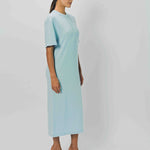 Alternate side view of cielo cashmere long t-shirt dress on model wearing sandals, against a white background.