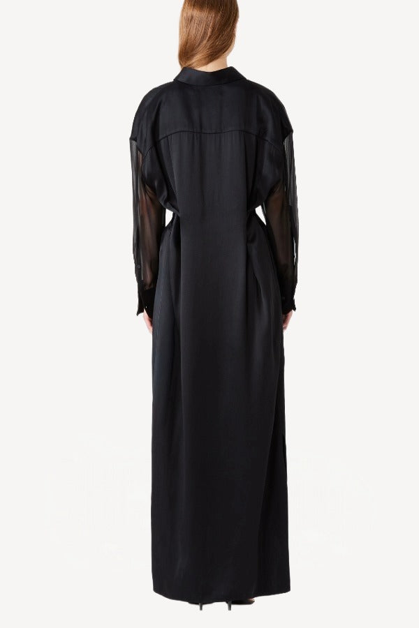 Back view of black francesca dress on model wearing black heels, against a white background.
