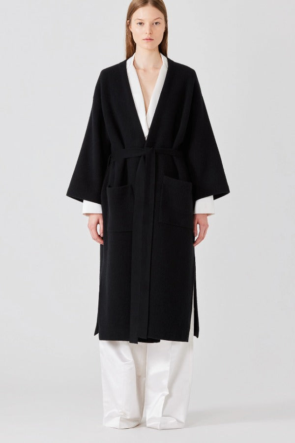 Front view of black isabella kimono coat on model wearing white top and pants, against a white background. 