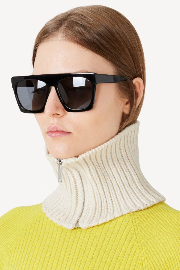 Front view of ivory knit cashmere collar scarf on model wearing a yellow sweater, against a white background.