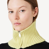 Front view of yellow knit cashmere collar scarf on model wearing black sweater, against a white background.