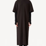 Front view of black knit cashmere collar scarf on model wearing brown dress, against a white background.