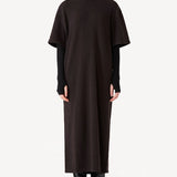 Front view of black knit cashmere collar scarf on model wearing brown dress, against a white background.