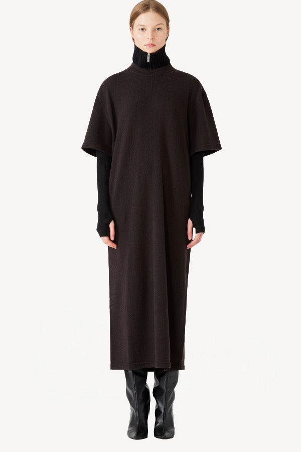 Front view of black knit cashmere collar scarf on model wearing brown dress, against a white background.