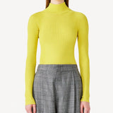 Front view of yellow l/s cashmere high neck sweater on model wearing grey pants, against a white background