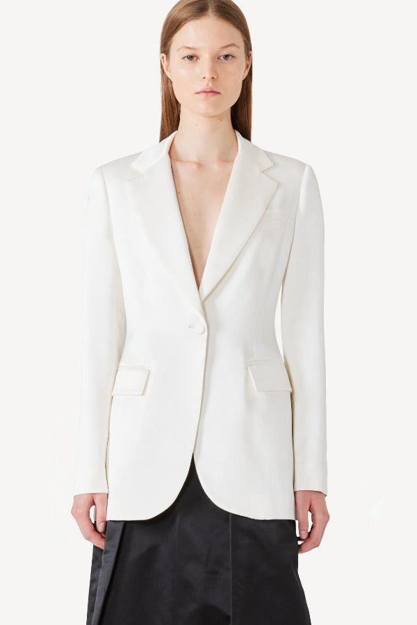 Front view of L/S double satin andrea blazer jacket on model wearing black skirt, against a white background.