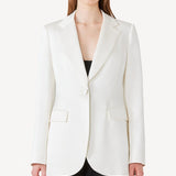 Alternate front view of ivory l/s double satin andrea blazer jacket on model wearing black pants, against a white background.
