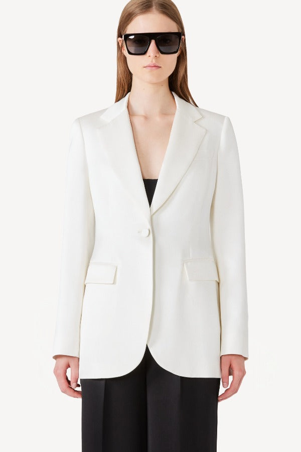 Alternate front view of ivory l/s double satin andrea blazer jacket on model wearing black pants, against a white background.