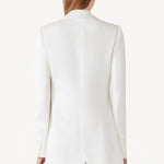 Back view of ivory l/s double satin andrea blazer jacket on model wearing black skirt, against a white background.