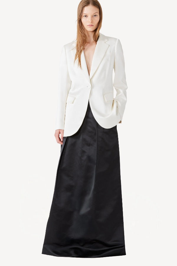 Alternate front view of ivory double satin andrea blazer on model wearing black skirt, against a white background.