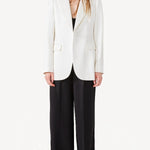 Alternate front view of ivory double satin andrea blazer on model wearing black pants, against a white background.