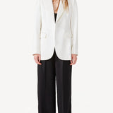 Alternate front view of ivory double satin andrea blazer on model wearing black pants, against a white background.