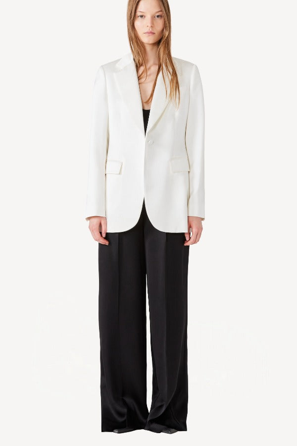 Alternate front view of ivory double satin andrea blazer on model wearing black pants, against a white background.