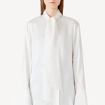 Front view of ivory L/S Double Satin Shirt with Scarf on model wearing black pants, against a white background.