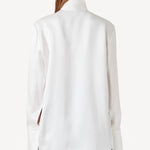Back view of ivory l/s double satin shirt with scarf on model wearing black pants, against a white background.