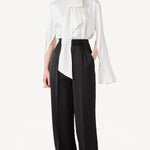 Front view of ivory l/s double satin shirt with scarf on model wearing black pants, against a white background.