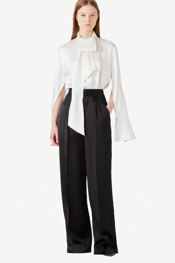 Front view of ivory l/s double satin shirt with scarf on model wearing black pants, against a white background.