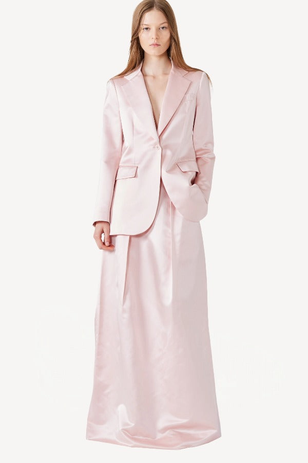 Front view of pink duchesse silk andrea blazer on model wearing pink skirt, against a white background.