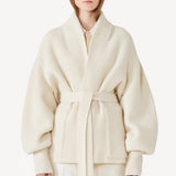 Front view of ivory gemma cardigan on model wearing white pants, against a white background.