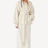 Front view of ivory gemma cardigan on model wearing white pants, against a white background.