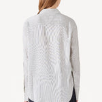 Back view of white/navy l/s silk marcella shirt on model wearing navy pants, against a white background.