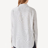 Back view of white/navy l/s silk marcella shirt on model wearing navy pants, against a white background.