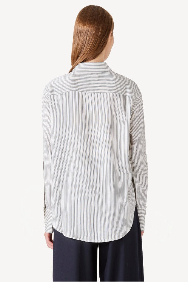 Back view of white/navy l/s silk marcella shirt on model wearing navy pants, against a white background.