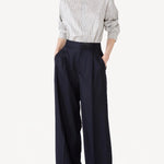 Front view of white/navy l/s silk marcella shirt on model wearing navy pants, against a white background.
