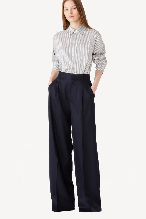 Front view of white/navy l/s silk marcella shirt on model wearing navy pants, against a white background.