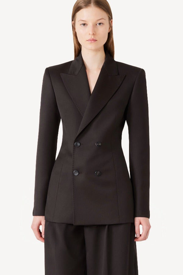 Front view of brown l/s wool double breast tuxedo jacket on model wearing brown pants, against a white background.