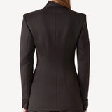 Back view of brown l/s wool double breast tuxedo jacket on model wearing brown pants, against a white background.