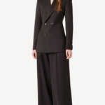 Front view of brown l/s wool double breast tuxedo jacket on model wearing brown pants, against a white background.